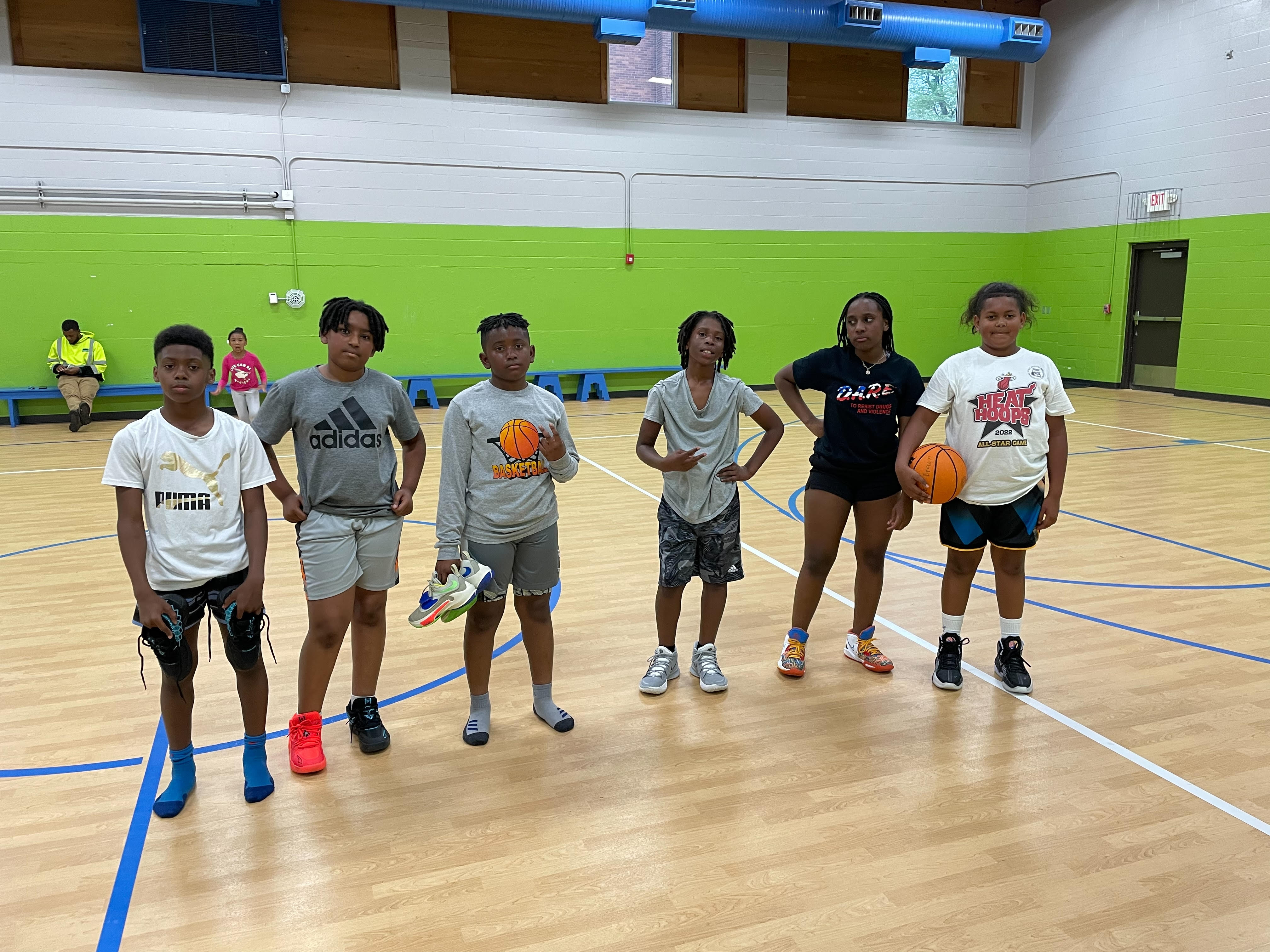 Young people standing together on a basketball court